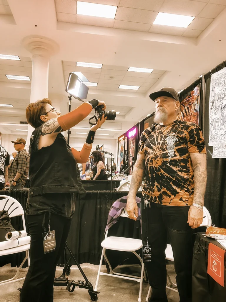 Adriana de Barros, tattoo journalist and photographer, photographing tattoo legend jack rudy